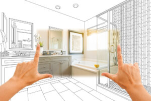 A person's hands with a blueprint of a bathroom in the background in El Paso.